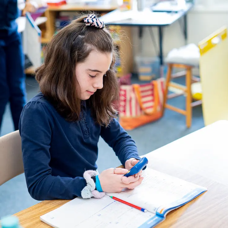 Lower School student using a calculator<br />
