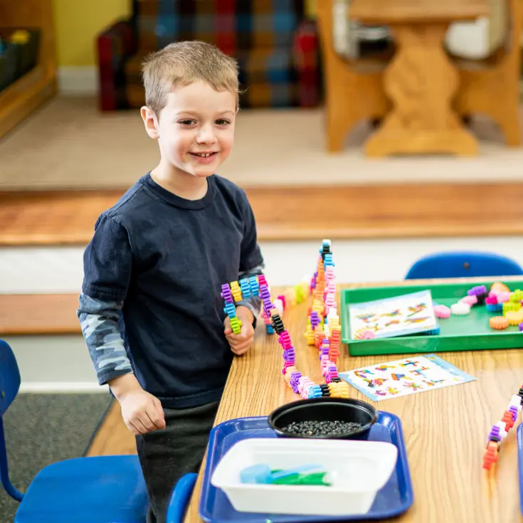 Little School student smiling at the camera