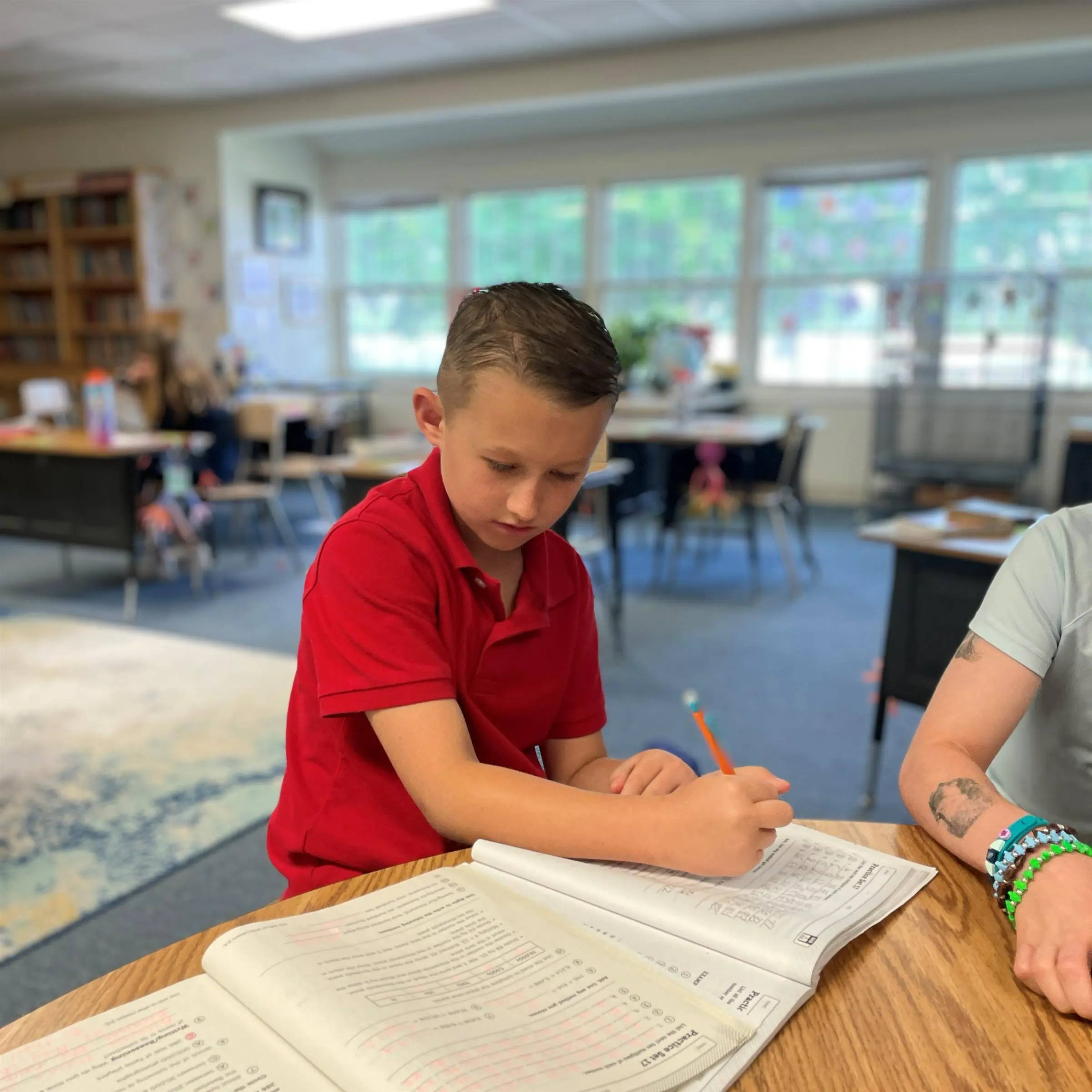 Kent School student writing in workbook