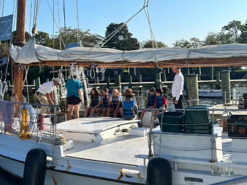 chesapeake-bay-studies-with-kent-school-students Kent School students outside on a boat participating in Chesapeake Bay Studies curriculum