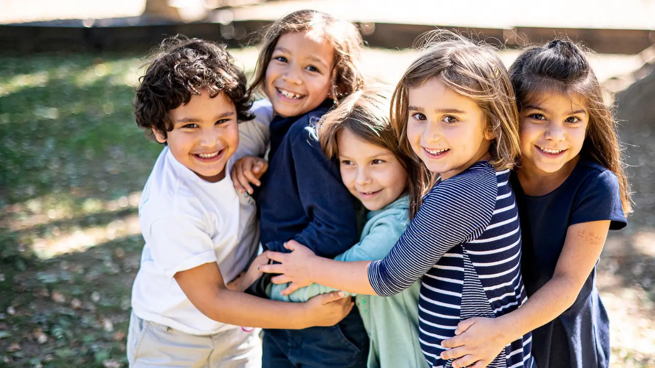 Little School children smiling on the Kent School playground